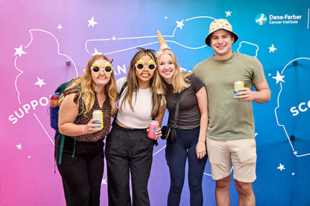 A group of people pose for a photo at Scoop at Night