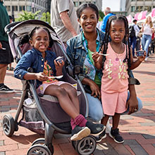 An adult and two children pose for a photo with some ice cream at Jimmy Fund Scooper Bowl